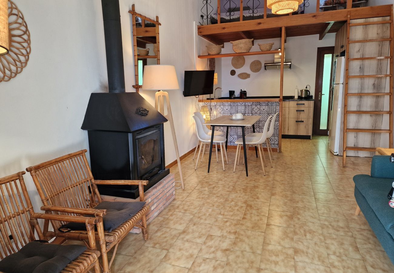 Open-plan dining area featuring a modern fireplace, dining table, and a view into a high-end open kitchen
