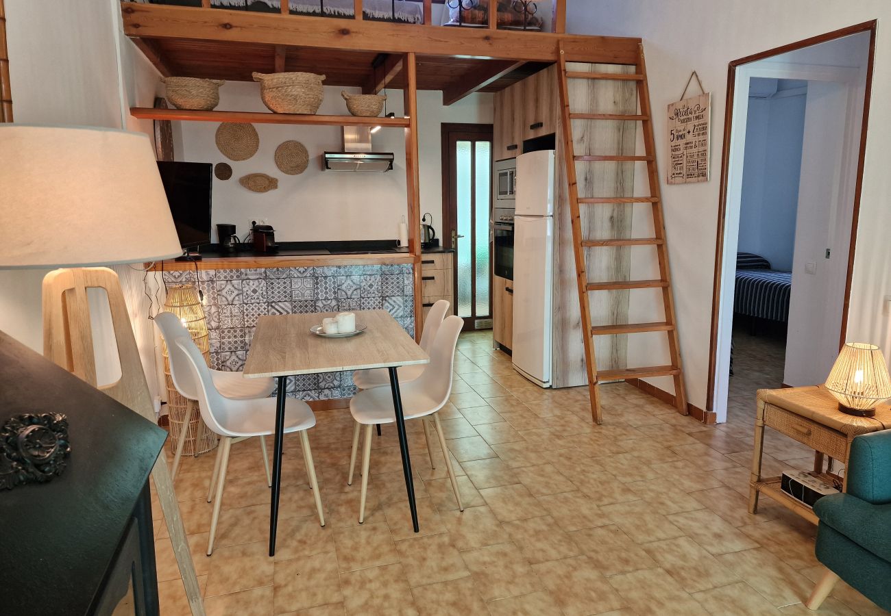 Open dining area with a direct view into the modern kitchen and the adjacent hallway.